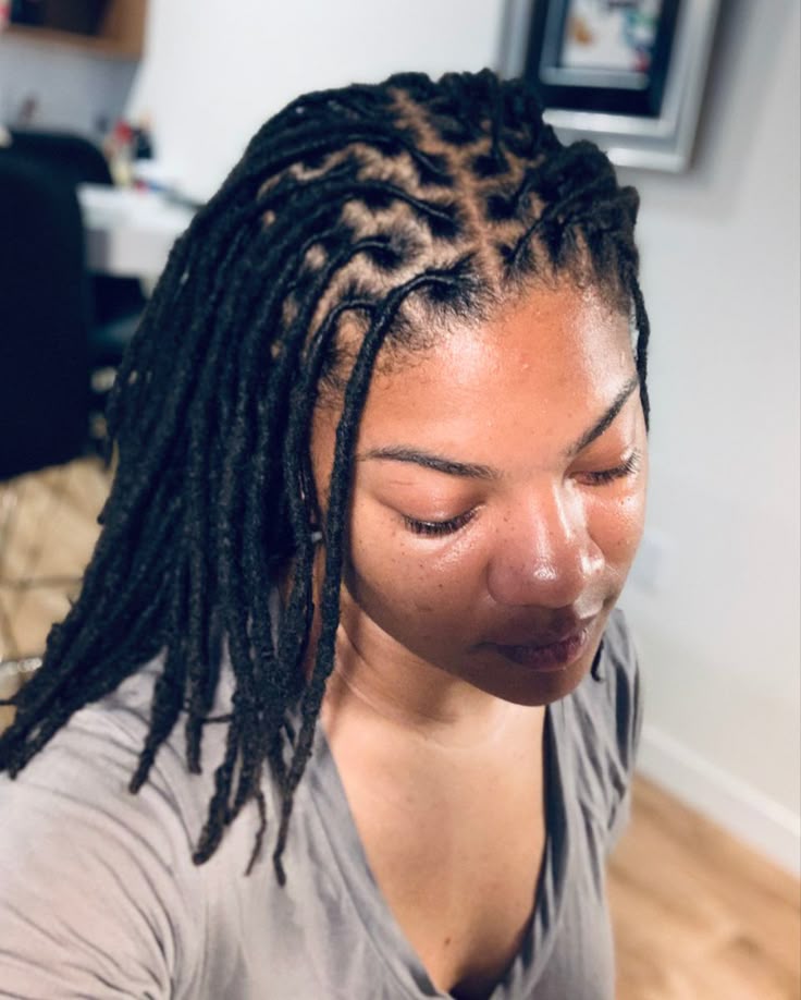 Freshly started locs with clean, evenly spaced parts across the crown