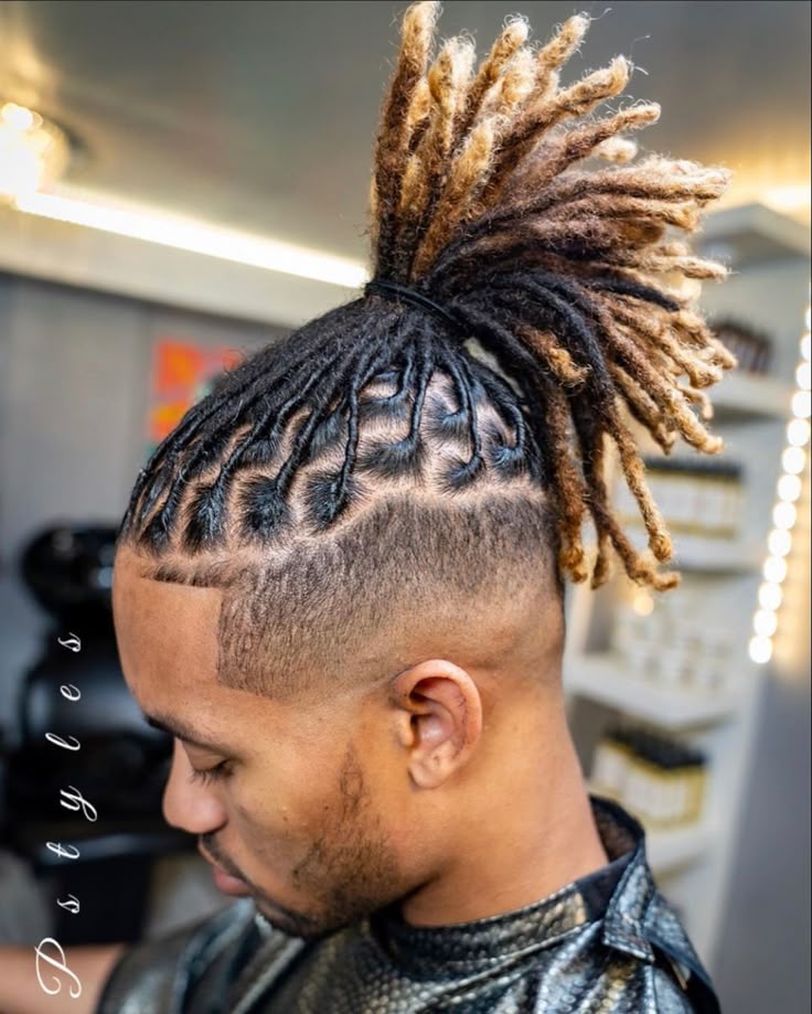 Locs gathered up top with the lengths lightened to blonde